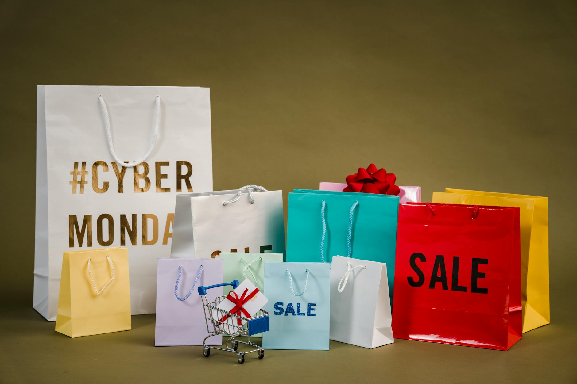 Kolorowe torby z napisem Cyber Monday i mini wózek z prezentami